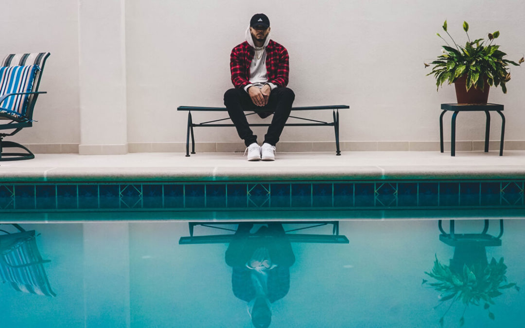 Man sitting in front of pool