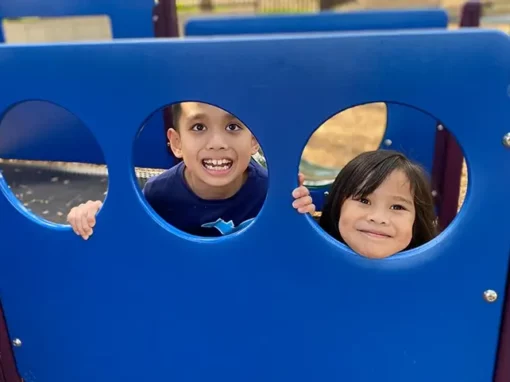 children having fun in the outdoor play structure